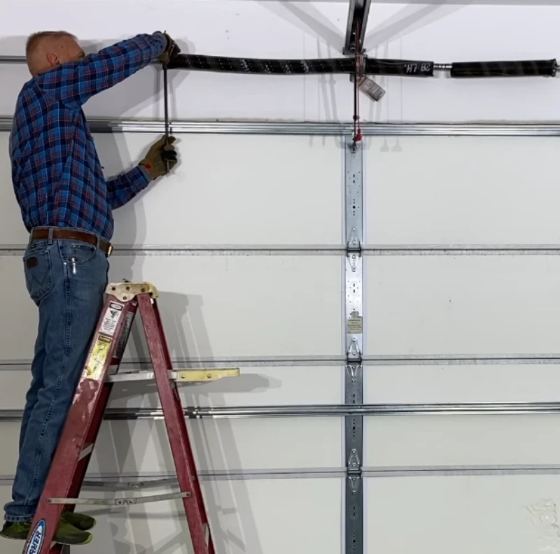 A professionally repaired garage door torsion spring, restoring smooth and safe operation.